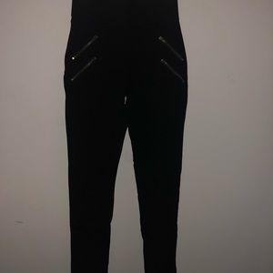 Black stretch pants with gold zippers